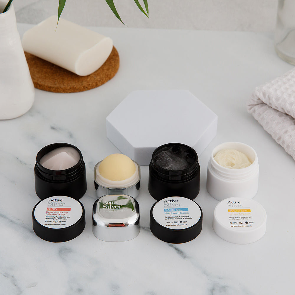 Mini Gift Set with lids off on a bathroom counter top